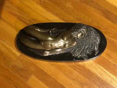 Bronze figure of "Decca", a nude reclining woman resting on a black marble base. Signed in script on...