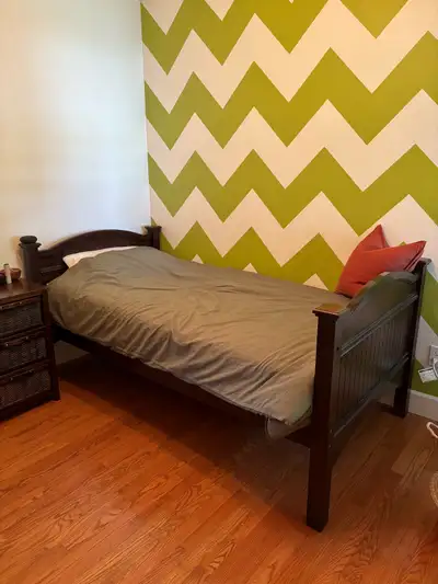 Solid wooden twin bedframe. In good condition. Was from a twin bunk bed so there are bolt holes from...