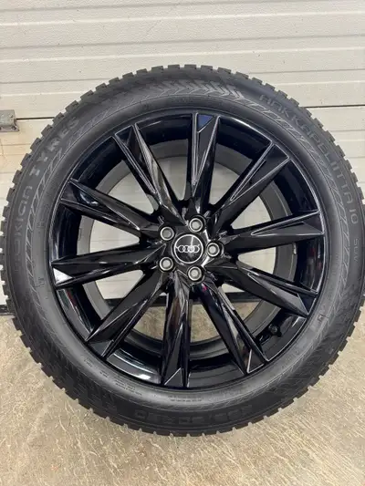 Offering a set of factory Audi winter rims paired with studded tires, sized at 255/50R20, these prov...