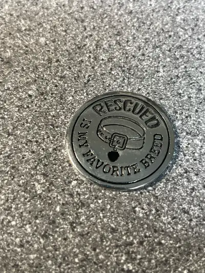 This delightful, used novelty coin features the phrase "Rescued Is My Favorite Breed," perfect for a...
