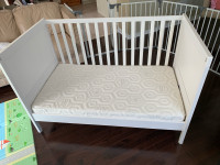 White Ikia baby crib with like new mattress still in plastic+