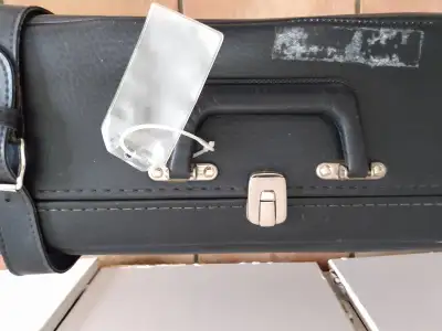 Vintage black suitcase with straps and buckles, View more