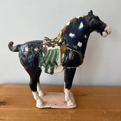 Reproduction Tang dynasty earthenware horse sculpture measuring 15.5” long x 14.5” tall. Minor repai...