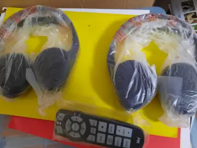 A set of 2 wireless head phones with remote control. New never used in original box. Works with most...