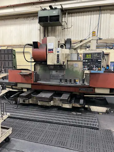 This Okuma & Howa Millac 8VA CNC milling machine features a Fanuc Series 15-M control. Tool changer...