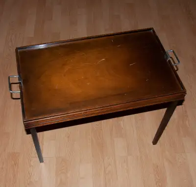 An extremely well made, George J. Lippert Limited folding/drop-leg butlers tray table. It features m...