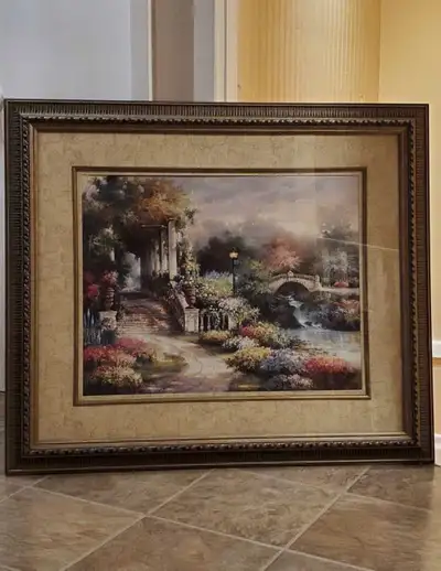 This elegant framed art piece features a serene garden scene, perfect for adding a touch of tranquil...