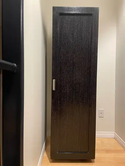 Black stained pine. Very gently used, with 3 shelves and 4 deep spaces. In perfect condition, includ...