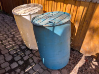 Two large plastic rain barrels 