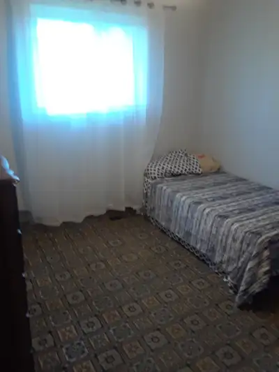 bright clean room for rent in older home on quiet street. shared bathroom and kitchen with cupboard...