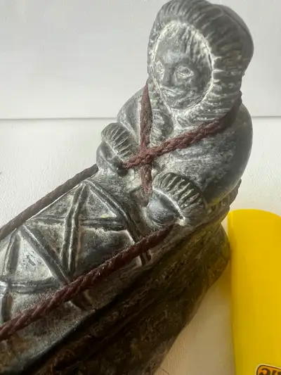vintage sculpture depicting an Inuit person, View more