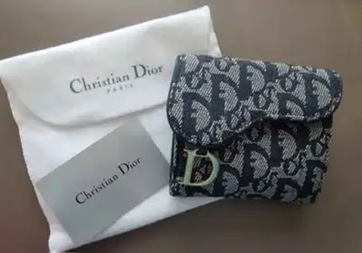 Authentic Dior Vintage saddle wallet is in brand new condition. Fits 4 card slots on each side, chan...