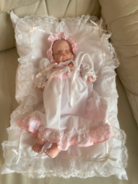 Porcelain Baby doll with cushion. Also plays a lullaby $20