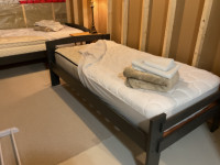 Single beds with mattresses.