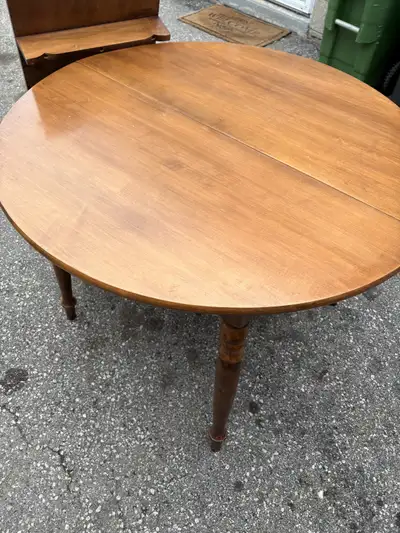 80$ 55 inch by 41 inch 30 inch high Wooden dining table with a drop-leaf extension. It's a light woo...
