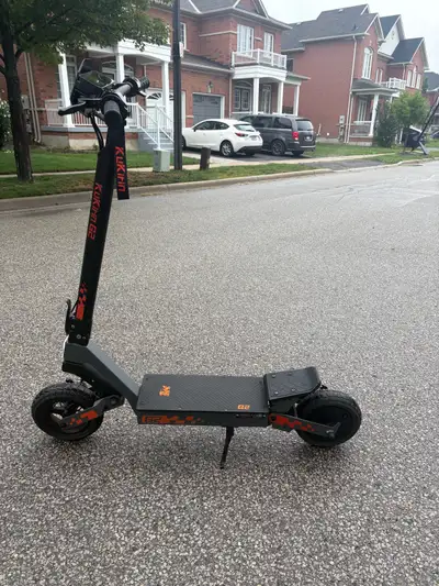 Powerful KuKirin G2 electric scooter is grey and black with orange accents. This model has a top spe...