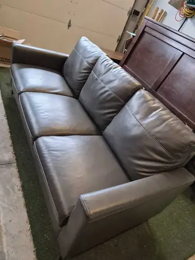 80" long by 34" deep grey leather sofa. In good condition, hardly used. Some small scratches from a...