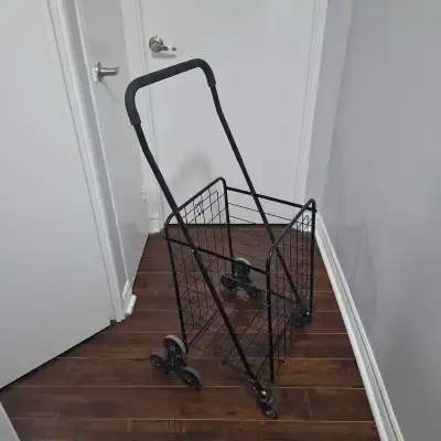 This pre-owned folding shopping cart features a practical stair-climbing wheel design, making it eas...