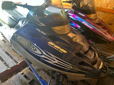 1999 and 2002 Polaris 500 Fan sleds. Both sleds and trailer in good shape ! 1999 is studded , both e...
