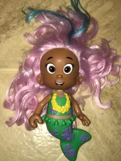 Molly is made of plastic, with the exception of her hair and is approximately 8 inches tall...her he...