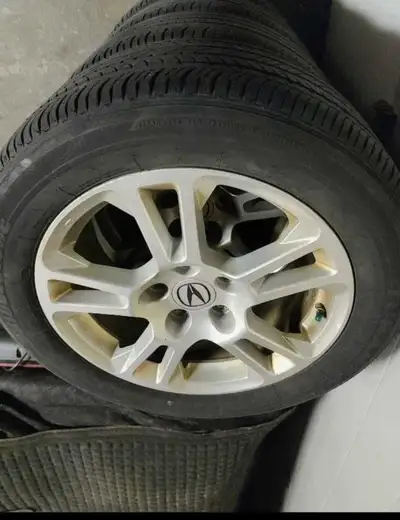 I am selling a set of four used Acura alloy rims paired with Bridgestone Turanza P245/50R17 tires. T...