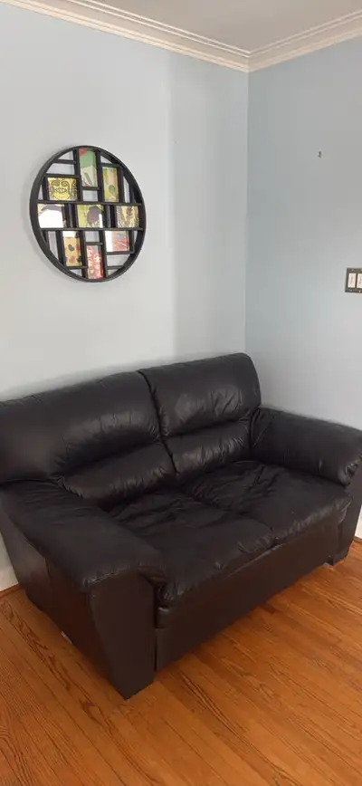 Black leather sofa pair, good condition & comes with leather cleaning kit from leons! One sofa is a...