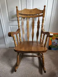Wooden rocking chair with carved back