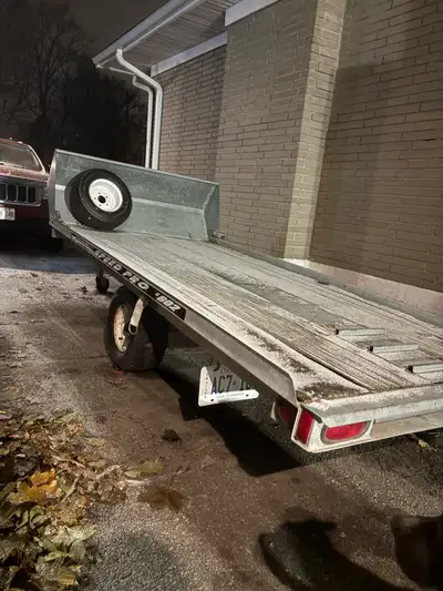 Tilting snowmobile trailer galvanized in great condition . Tires are perfect also comes with a spare...