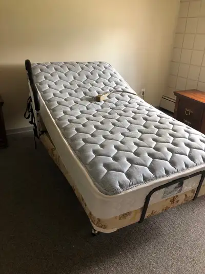 Regular Single Bed Mattress, in good condition, easily moved frame on wheels . Adjustable foot and h...