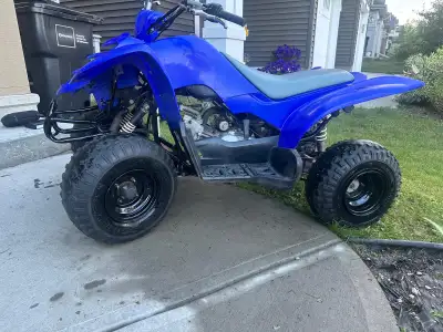 youth-sized ATV with a 80cc, air-cooled, four-stroke engine and a three-speed transmission with an a...