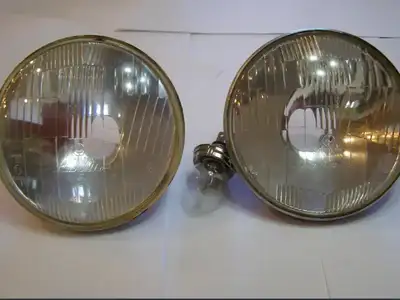 Selling a 1960's NOS pair of Carello 7" headlights , appear to have been made in differing times/bat...