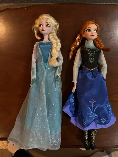 Disney store exclusive Frozen Elsa and Anna 16 “ dolls . They each play a song and light up . Both a...