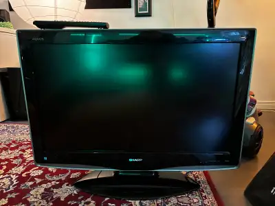 32” flat screen Sharp Aquos TV w remote. This is not a smart TV but has all the connections . In gre...