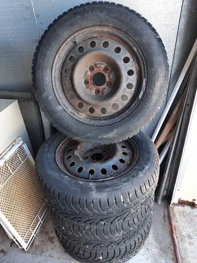 17 Inch Chrysler Rims Snow tires mounted and balanced. Good for another season, Or two , depending o...