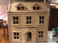 Wooden dollhouse with multiple furniture sets and wooden dolls