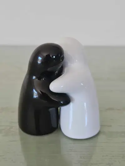 These adorable hugging ghost salt and pepper shakers feature a charming black and white design, perf...