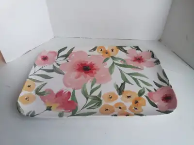 This is a serving tray that can be used all year long. It has flowers on it. It is made of hard plas...