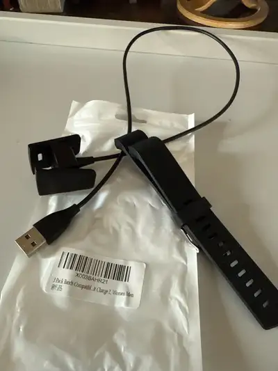 Fitbit charge 2 usb charger and black unisex band. Cans is new , charger in great irking condition.