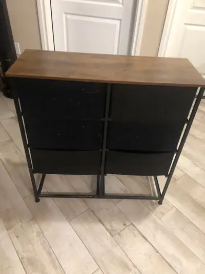 storage dresser features a wood top and black metal frame with 6 black fabric drawers, perfect for a...