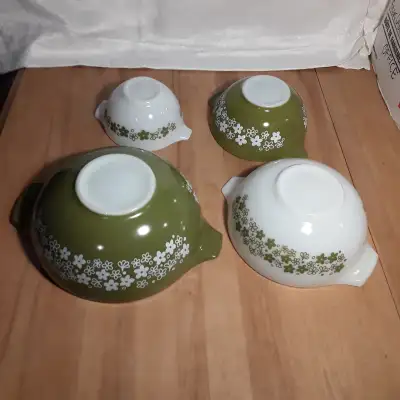 A complete set of four nesting mixing bowls with handles that double as pour spouts. (known as Cinde...