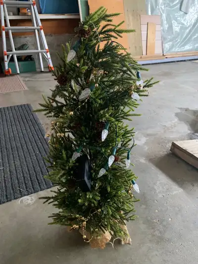 Plastic tree. With battery operated light. Weighted base. Batteries not included. 15” tall