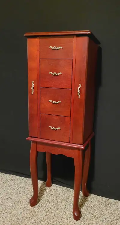 Standing Jewelry armiore with a cherry finish. Lots of space to store Jewelry!! In good condition. P...