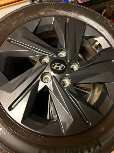 Full set of four P205/55R16 Kumho all season tires mounted on OEM factory Hyundai Elantra aluminum r...