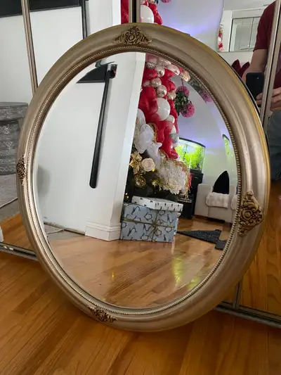 Selling a 26" X 30" oval mirror as seen in the picture. It is designed with hangers on it's back for...