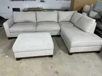 Cream sectional with storage ottoman