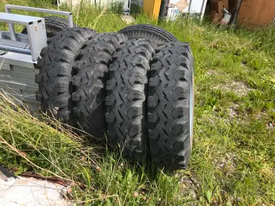 900 20 tires, set of 6 no cracks, mounted on Dayton Rims, Back 4 grip, and two steering tires, 6 for...