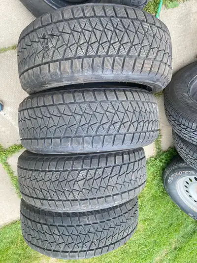 A set of 4 Top of the line Bridgestone Winter Tires with tons of tread all evenly worn barley driven...