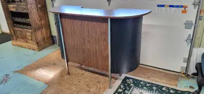 Unique retro bar with chrome legs and brown veneer top and front. Plenty of bar storage. Ready for e...