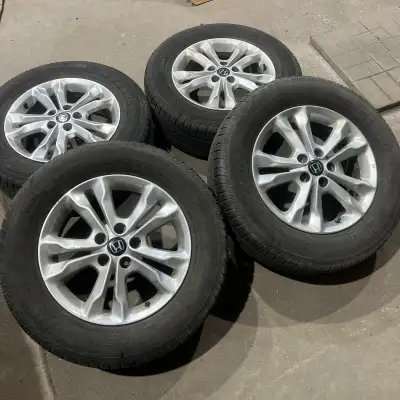 Set of four 235/65/17 Continental all season tires mounted on aftermarket aluminum alloy rims. Tires...