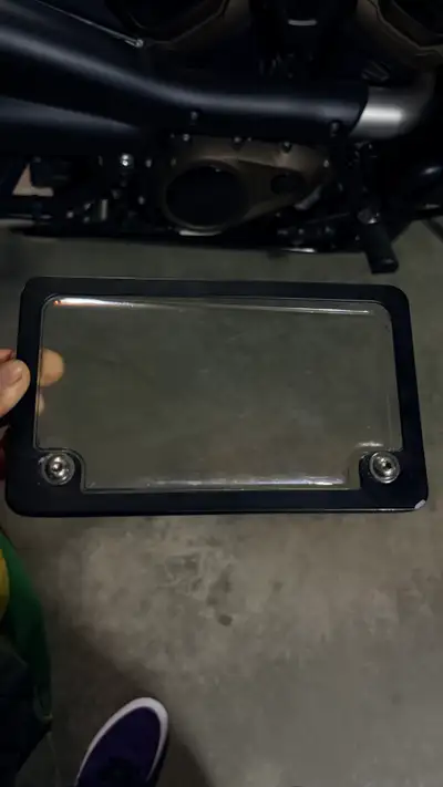 Protect your plate with this sleek, black, used motorcycle license plate cover, measuring approximat...